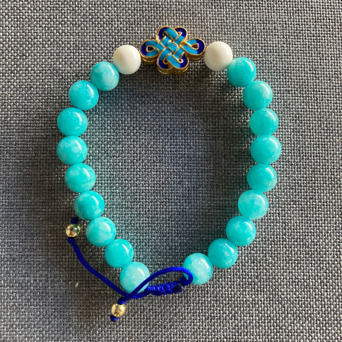 Pulsera de jade azul 8 mm con detalle de Concha y Nudo Infinito esmaltado, ajustable